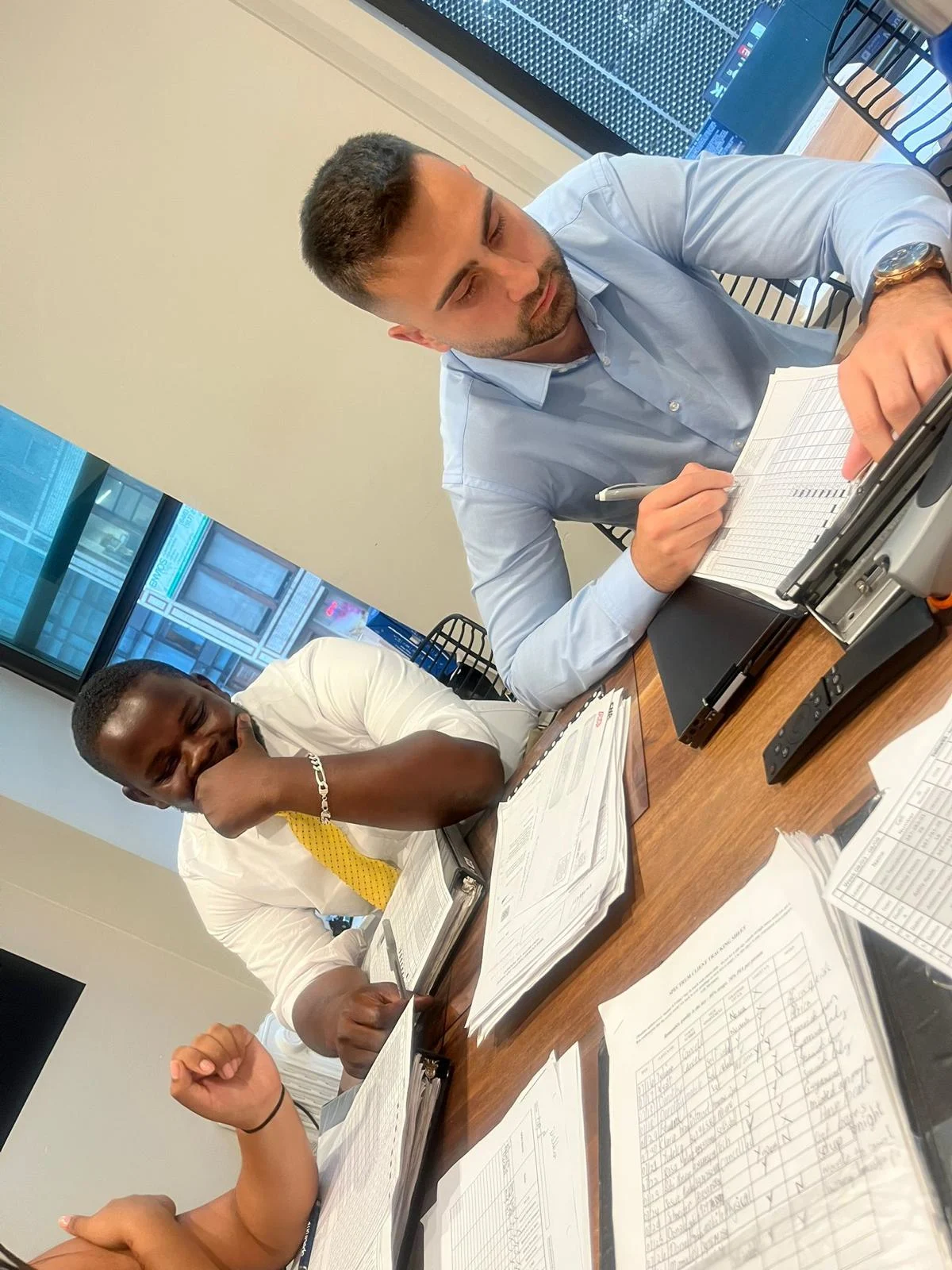 FollowUS team members in a mentorship meeting reviewing performance